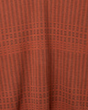 Close-up of the knit structure on the Mustang Stripe Polo Knit in rust
