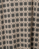 Close-up of the Dhaka-inspired check jacquard used for the knit shirt