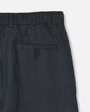 Close-up of the rear welt pocket and elasticated waistband on the Dekk Trouser in dark grey