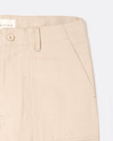 Close-up of the angled front patch pocket and waistband on the Coup Trouser in tan