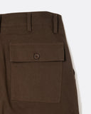 Close-up of the buttoned rear fatigue pocket on the Coup Trouser in brown