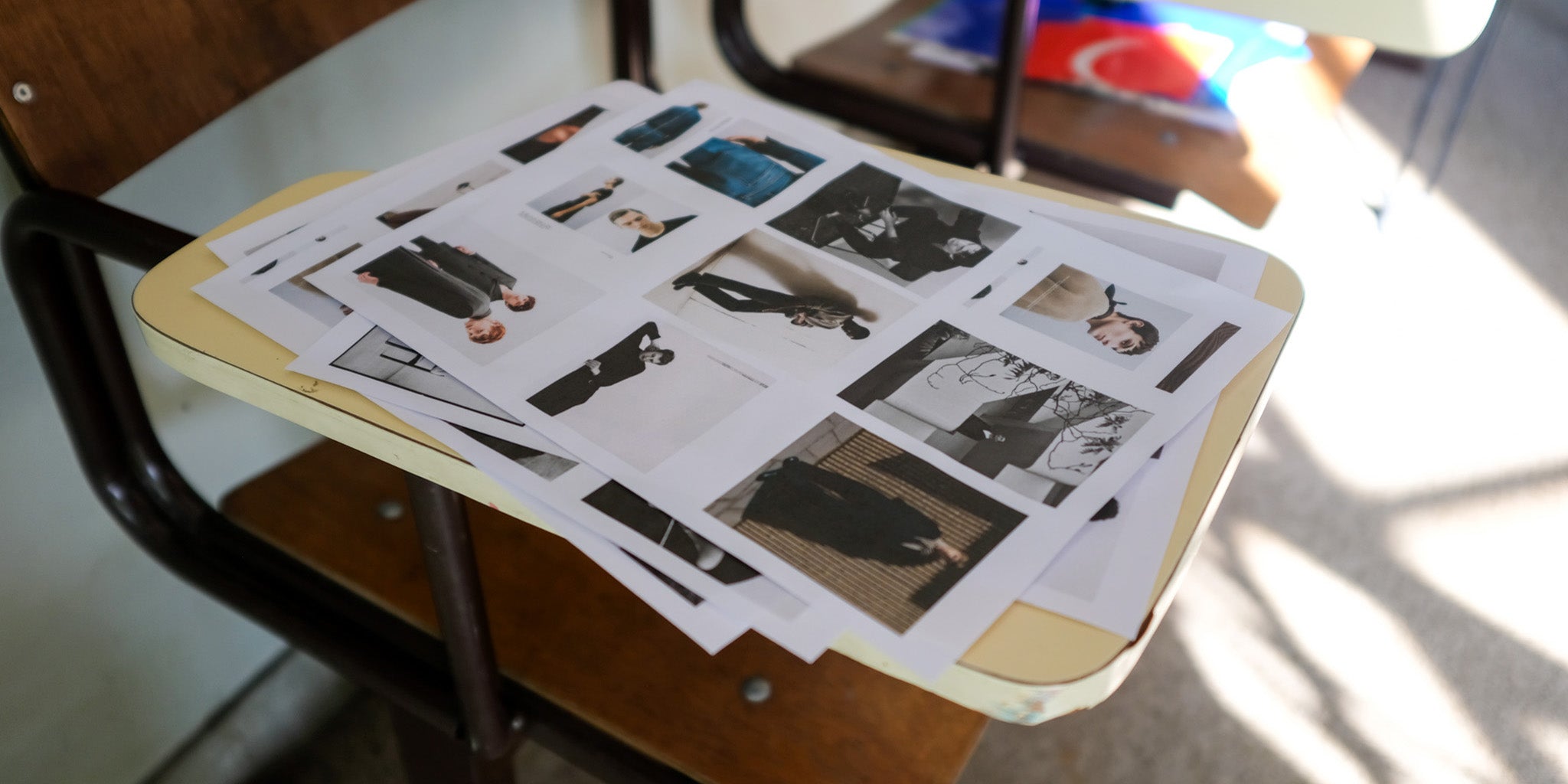 Autumn/Winter '25 - BTS: Contact sheets and reference printouts on a school chair
